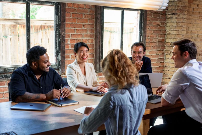 A group of MVMNT employees during a meeting.