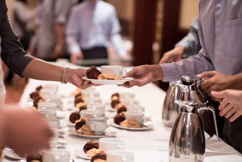 Man serving breakfast at corporate event