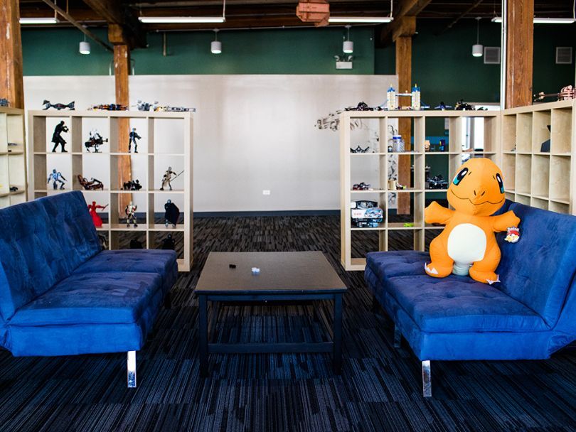 Image of a couch and collectibles in Nerdery's office 