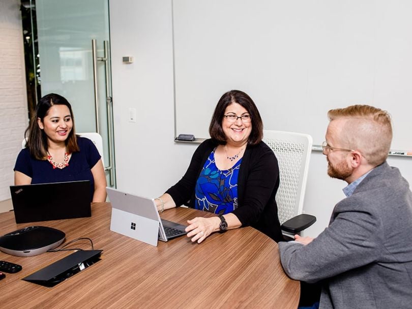 Tracy McCarthy talks with coworkers
