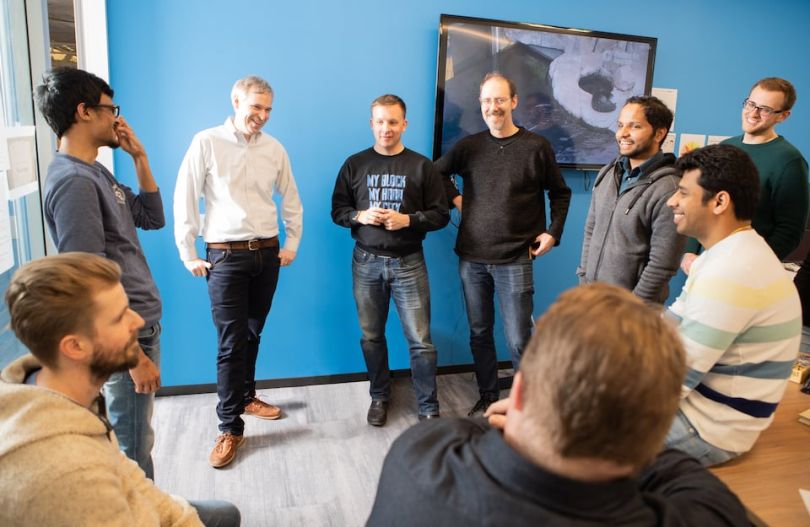Opploans team standing in a circle, chatting