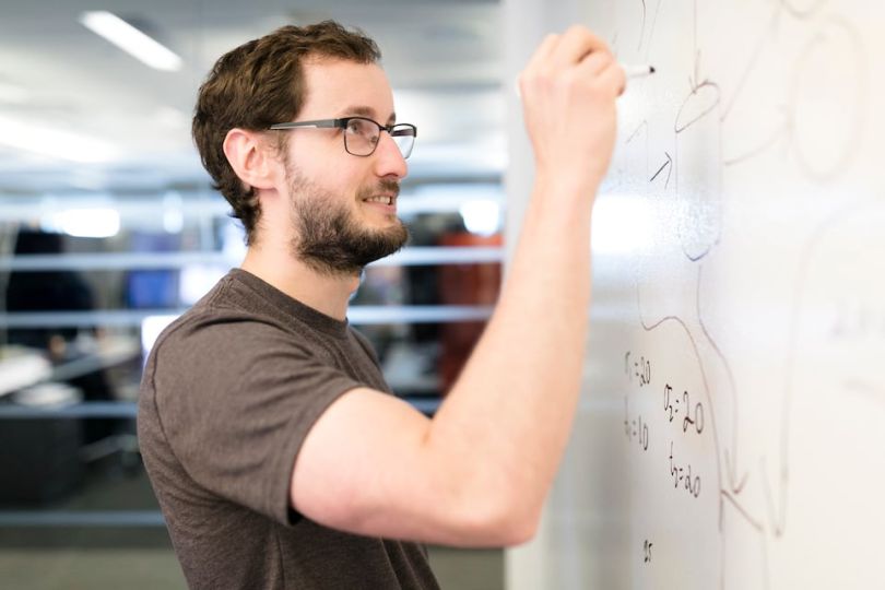 Optiver Head of IT Operations Casey Kisselburg working at a whiteboard
