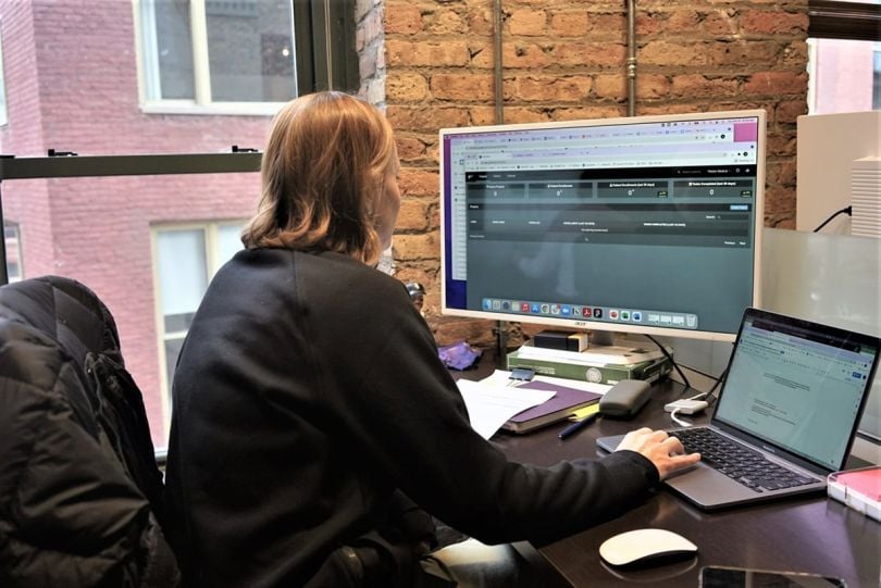 PaitentIQ team member working on a computer