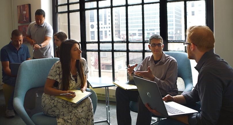 Rewards Network staff working next to window