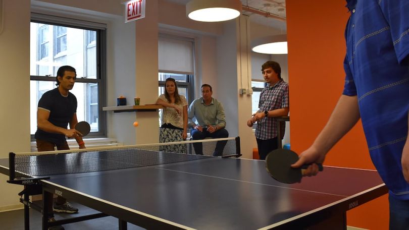 Rewards Network team members playing ping pong
