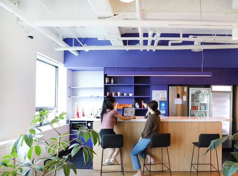 Two Sendbird employees work on a project in the office.