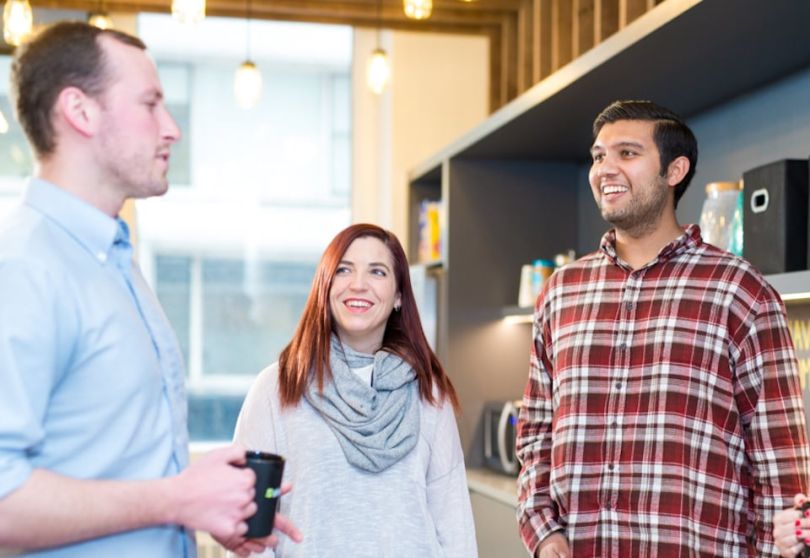 Shiftgig team members chatting in their office
