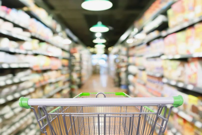 Shopping cart in grocery aisle