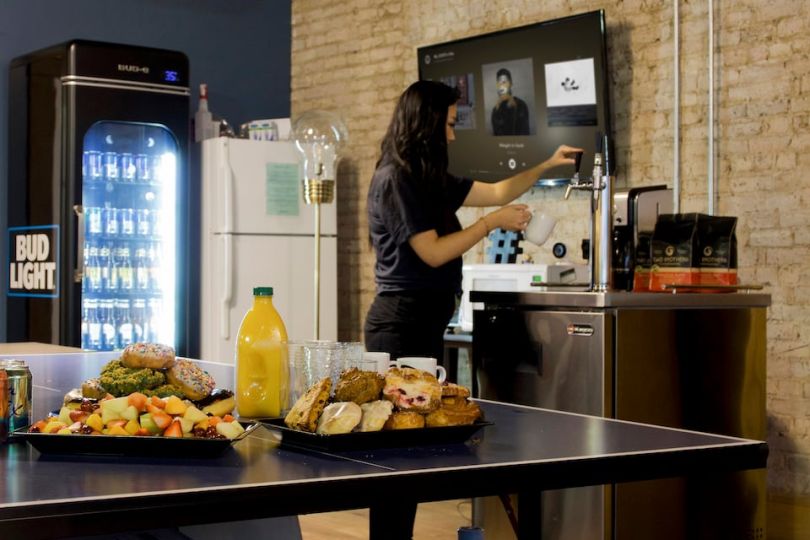UPshow employee using cold brew machine in office