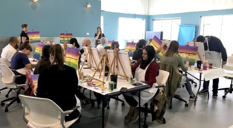 Volusion team members painting
