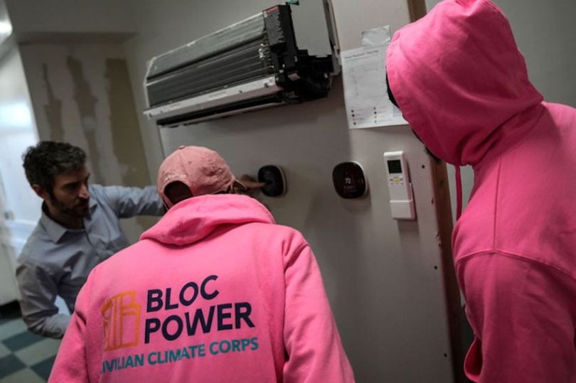 Workers from BlocPower’s NYC Civilian Climate Corps learn about green energy building improvements.