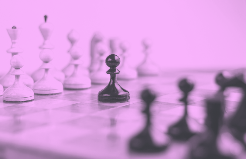 Pawn piece in the middle of a chess board.