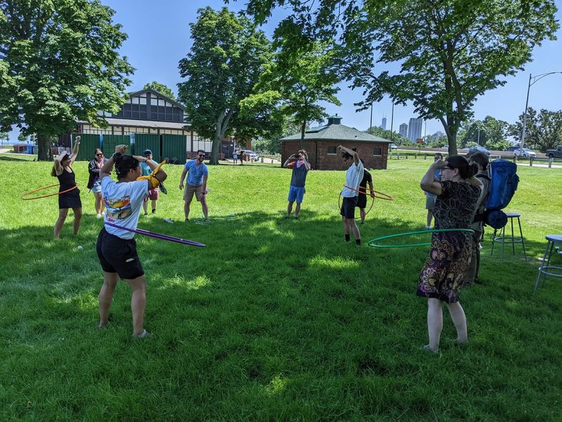 dscout team members playing with hula hoops in a park