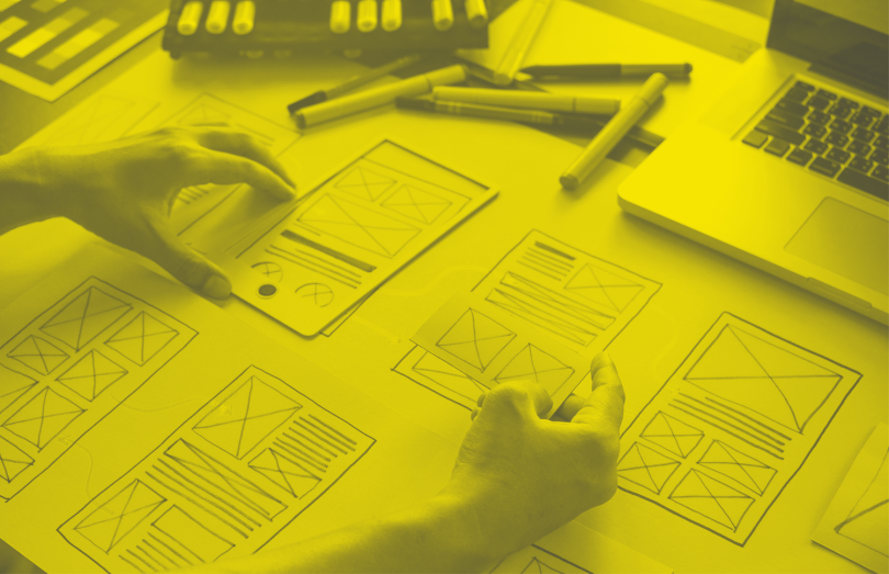 A product designer sketches prototype interfaces