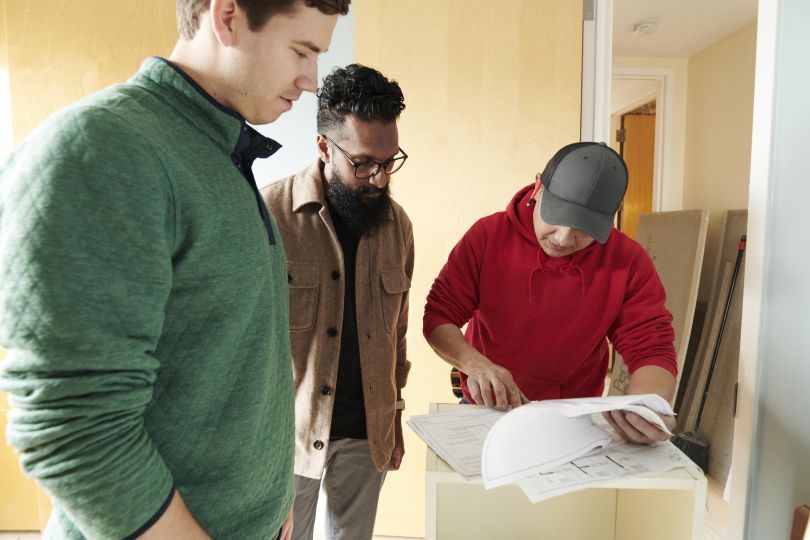 three Block Renovation employees looking over documents