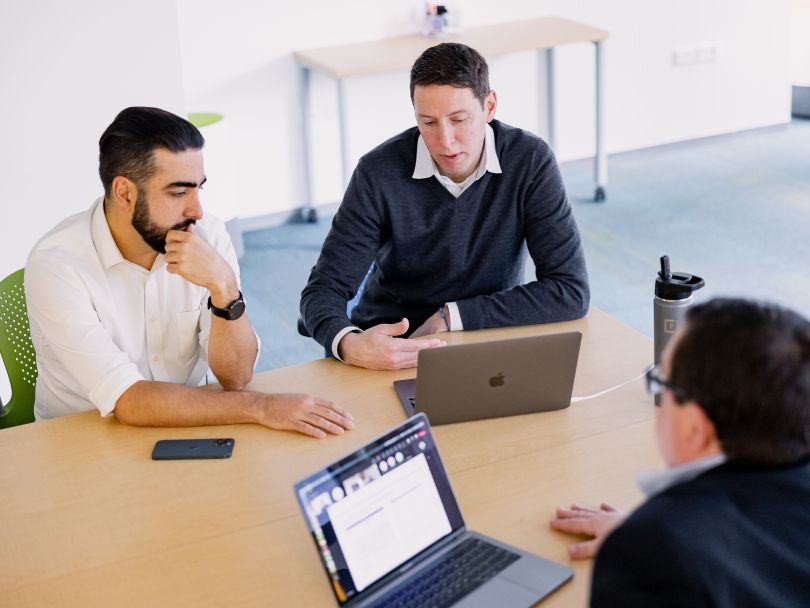 10Pearls team members having a discussion in the company’s office