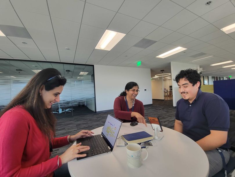 Members of the Abalta team confer at a table