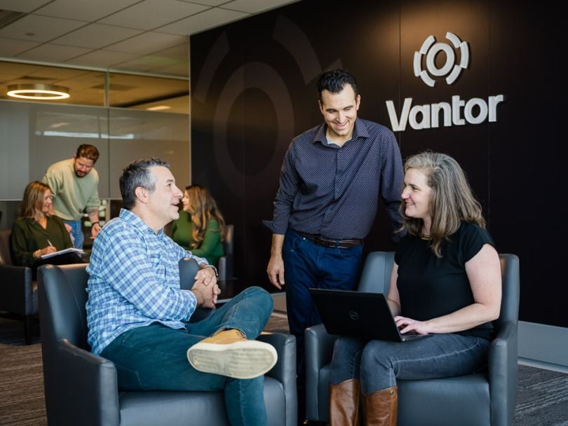 Eric DePinto chatting with two of his colleagues in the Vantor office