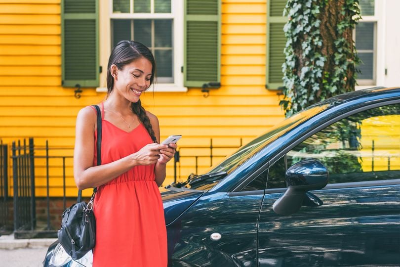 Woman using a rideshare app on a cellphone