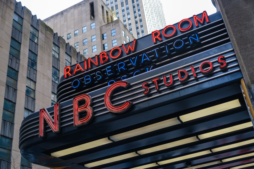 New York, NY, USA - November 16, 2022: An NBC Studios sign advertising the Rainbow Room and Observation Deck on the side of 30 Rockefeller Plaza in midtown Manhattan.