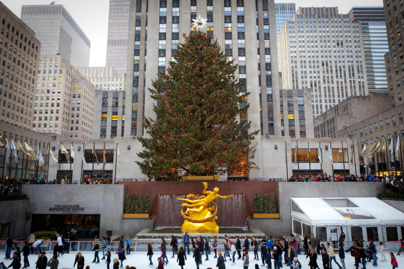 NEW YORK - DECEMBER 26: The Rockefeller Center Christmas Tree and statue of Prometheus above the ice rink on December 26 2012 in Manhattan New York. Rockefeller Center is a National Historic Landmark