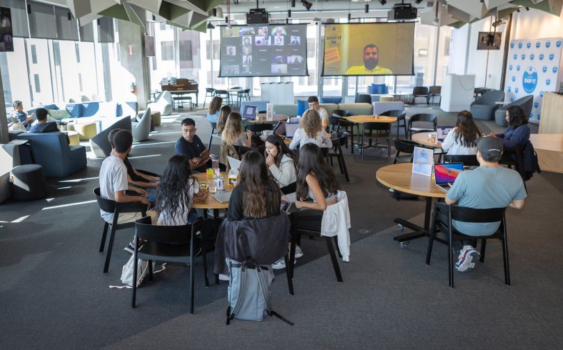 The Atlassian team working and eating in an office lounge-cafeteria setting