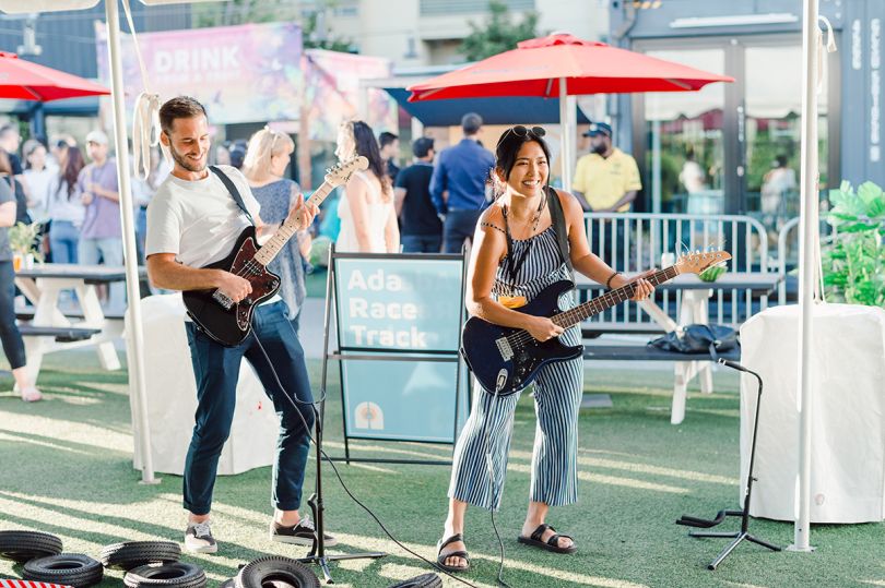 Two ADA team members playing guitars