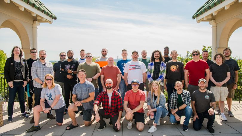 Large group photo of AWeber Communications’ staff, taken on an outdoor patio.