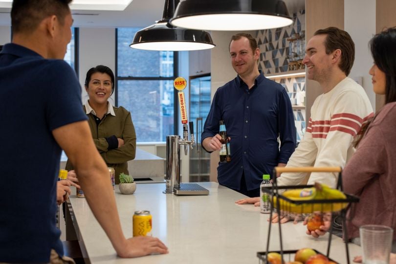 Adyen team members chatting in office kitchen