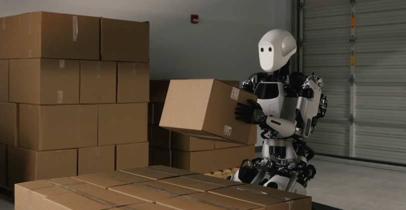 Apptronik's humanoid robot, Apollo, carries a package in a warehouse.