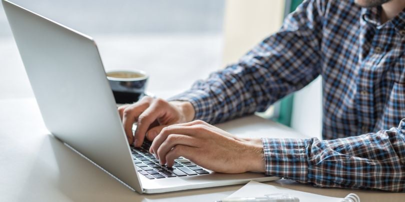 person typing on laptop