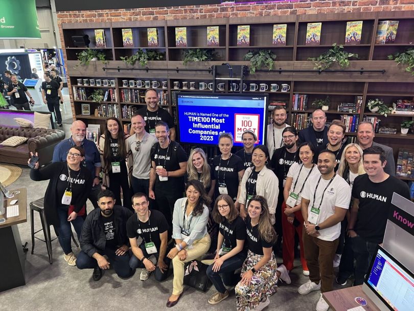 HUMAN team members pose for a group photo at a conference. 