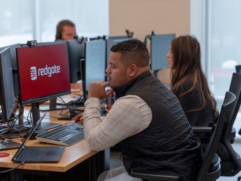 three employees working at their desks