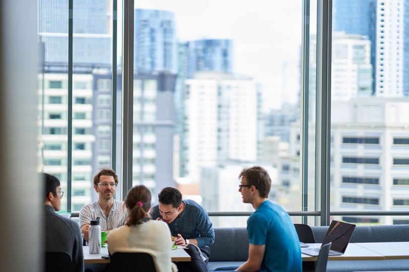 Benchling team members sitting at a table with a view of San Francisco out the window