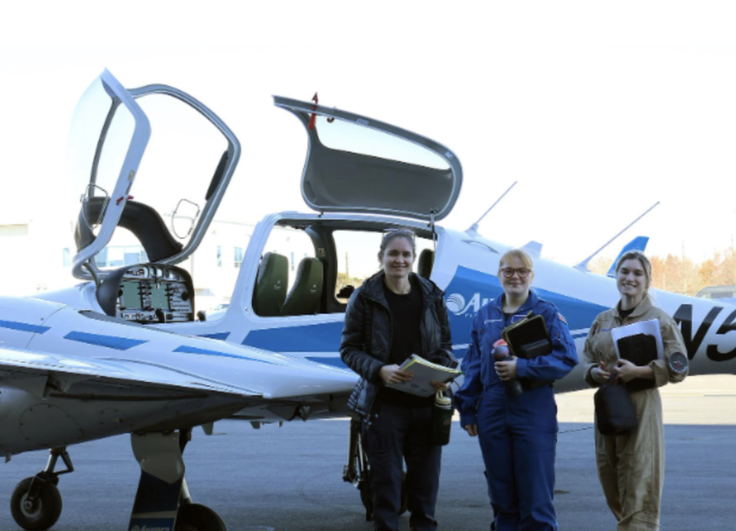 Boeing Test & Evaluation flight test engineers Caitlin Boxell, Maisie Dobbs and Maiah Spong stand with an Aurora Flight Sciences’ Centaur aircraft during a recent Flight Test Bootcamp.