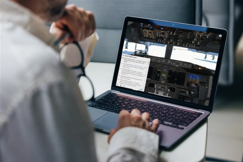 An image of a man using Boeing’s Virtual Airplane Procedures Trainer on his laptop computer