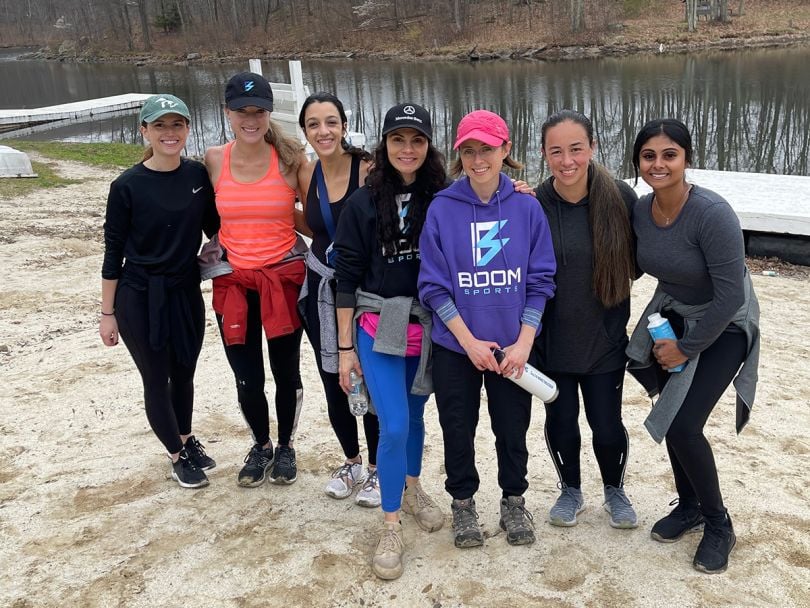 Boom Entertainment team members on the sand by a lake