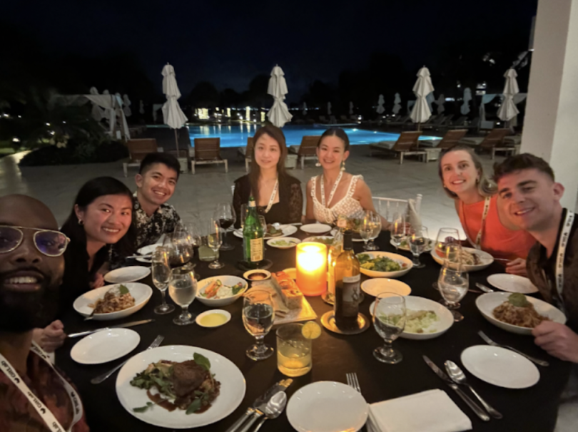 Account Executive Brady O’Dowd and several of his colleagues pose for a photo while eating dinner during the Presidents Club trip in Anguilla