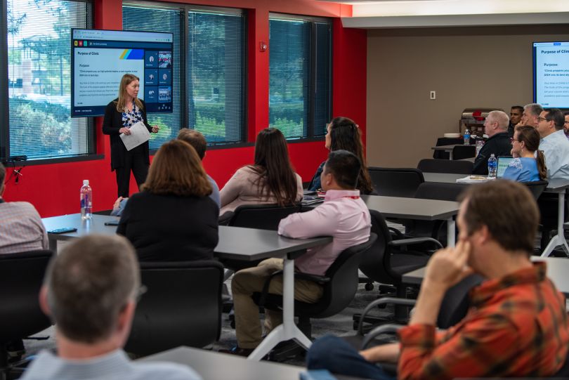 Photo of DISH team members watching a presentation at a professional development event.