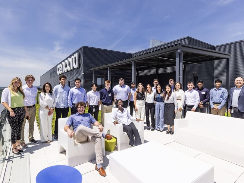 The Cencora team poses for a group photo on the rooftop terrace of their office.