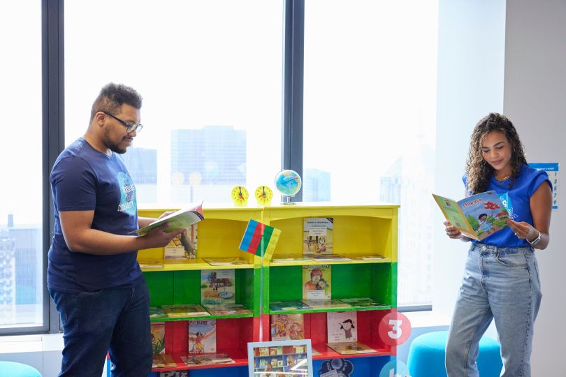 IMC Team members read Room to Read books. 