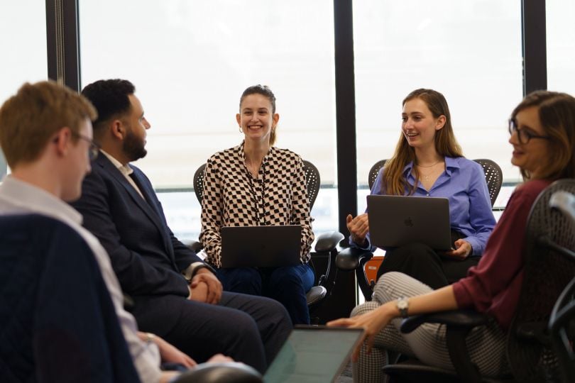 Candid photo of AlphaSights team members in a meeting.