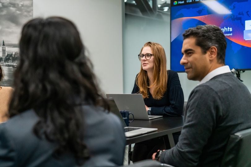 Candid photo of AlphaSights team members in a meeting.