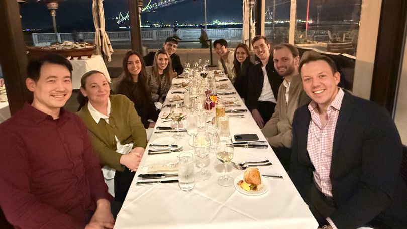 Collectly employees at a table eating together