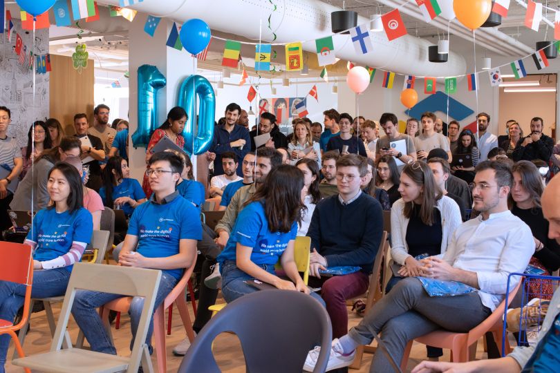 Contentsquare gathered in office for presentation wearing branded t-shirts