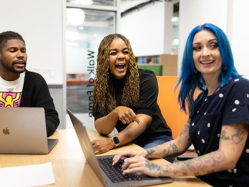 Members of the Core Digital Media team sharing a laugh in the office