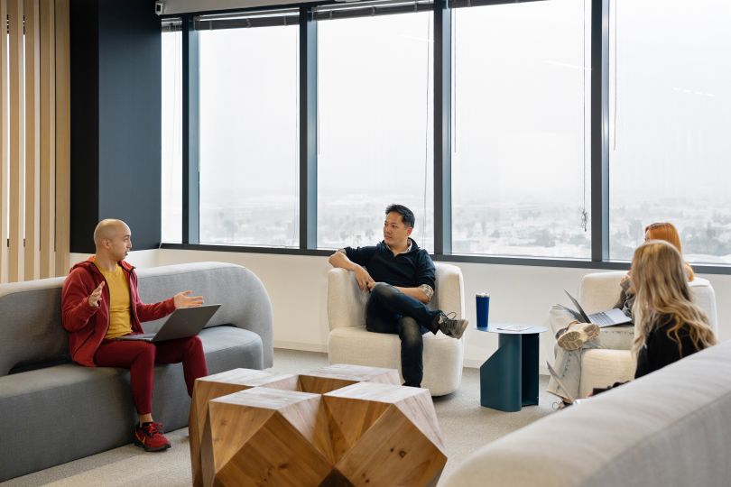 Photo of Demand.io office with people sitting on couches talking