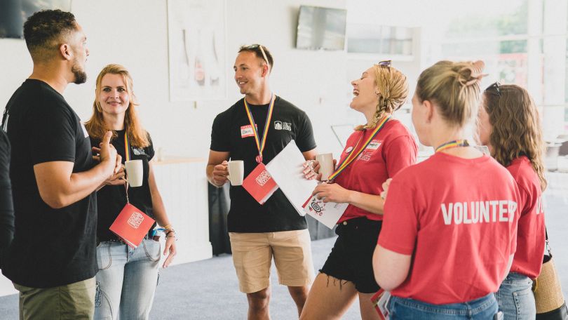 Group of Redgate employees standing, talking and laughing 