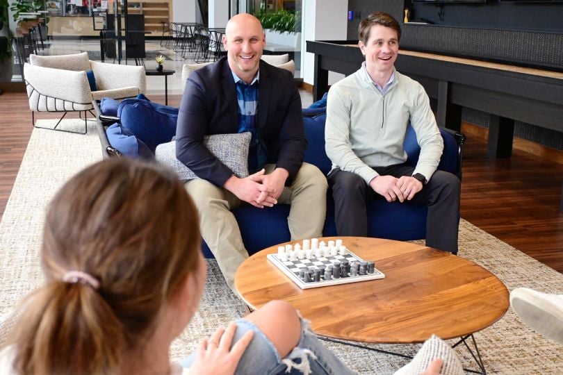 Center team members sitting around a chessboard