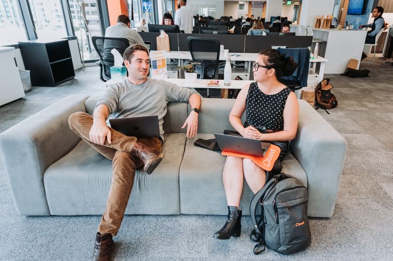 Two Toast colleagues sitting on a couch talking